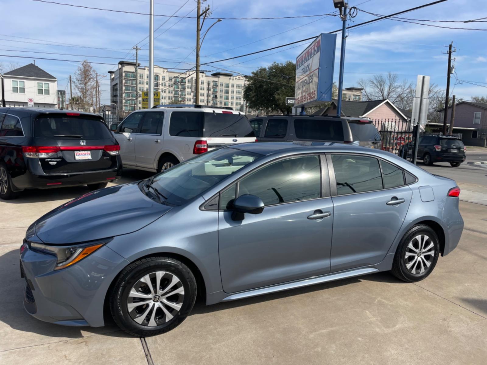 2022 Blue /Silver Toyota Corolla LE (JTDEAMDEXNJ) with an 1.8L Hybrid engine, Automatic transmission, located at 1501 West 15th St., Houston, 77008, (713) 869-2925, 29.797941, -95.411789 - Photo #0
